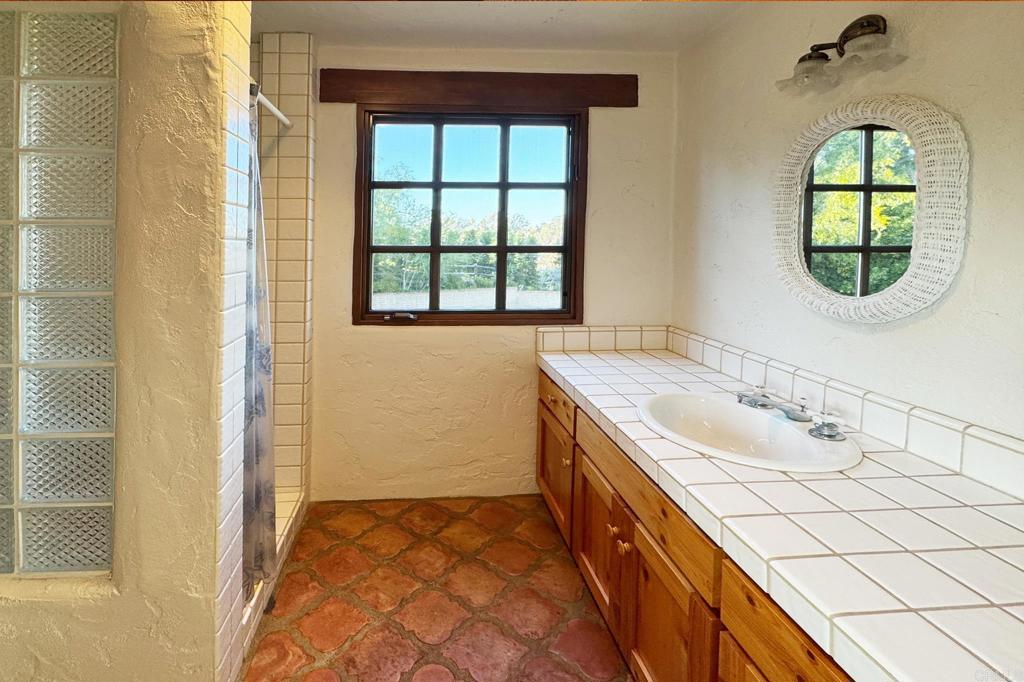 5443 Calzada Del Bosque Rancho Santa Fe, CA 92067 - Photo 51 of 63 a bathroom with a sink and a mirror