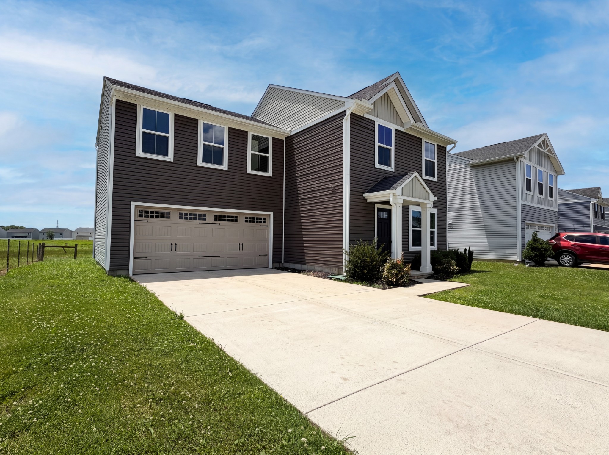 937 Blue Ash Way Christiana, TN 37037 - Photo 2 of 22 a front view of a house with a yard and garage
