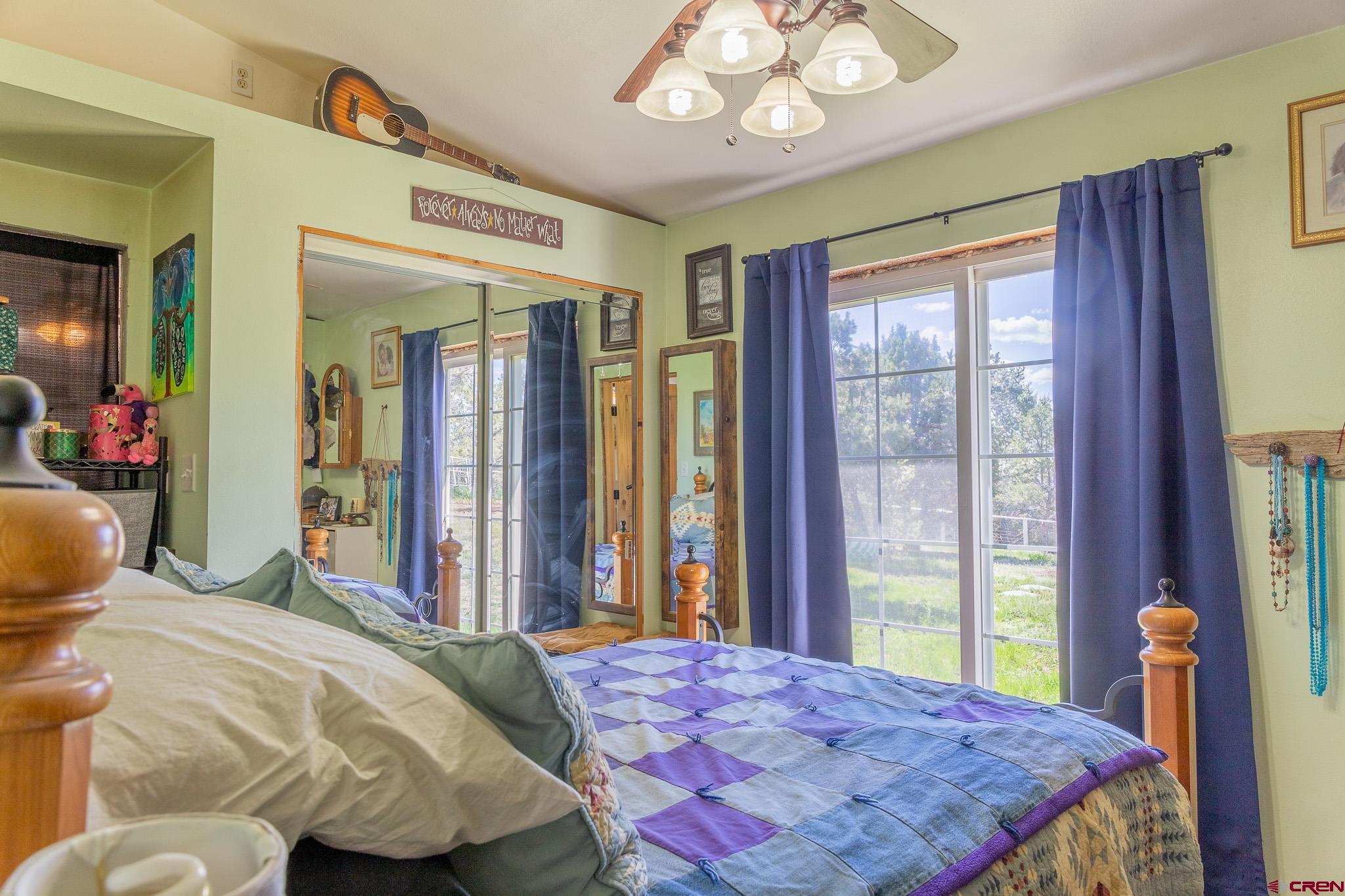 329 Payne Lane Ignacio, CO 81137 - Photo 11 of 45 a bedroom with a bed and a large mirror next to a window
