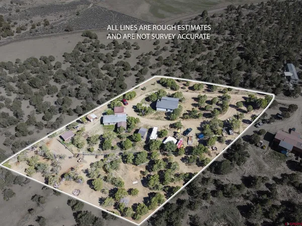 a view of a yard with a tree in the background