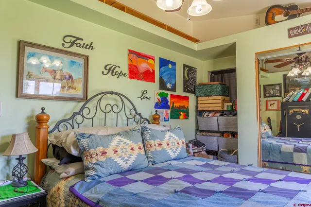 a bedroom with a bed a dresser and book shelf