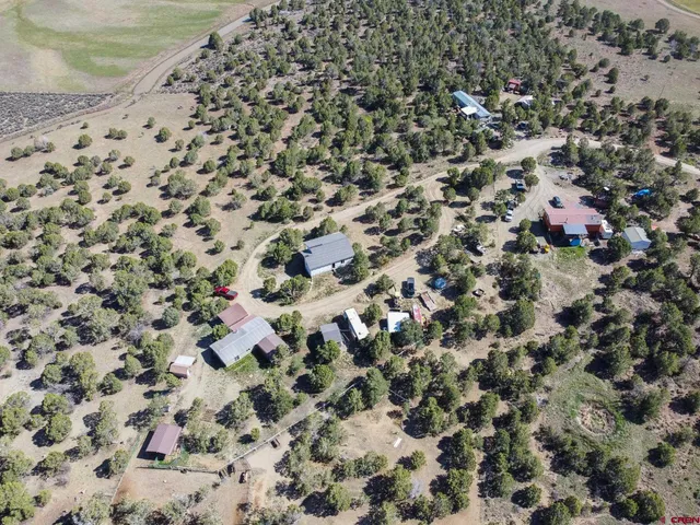 an aerial view of residential house with parking