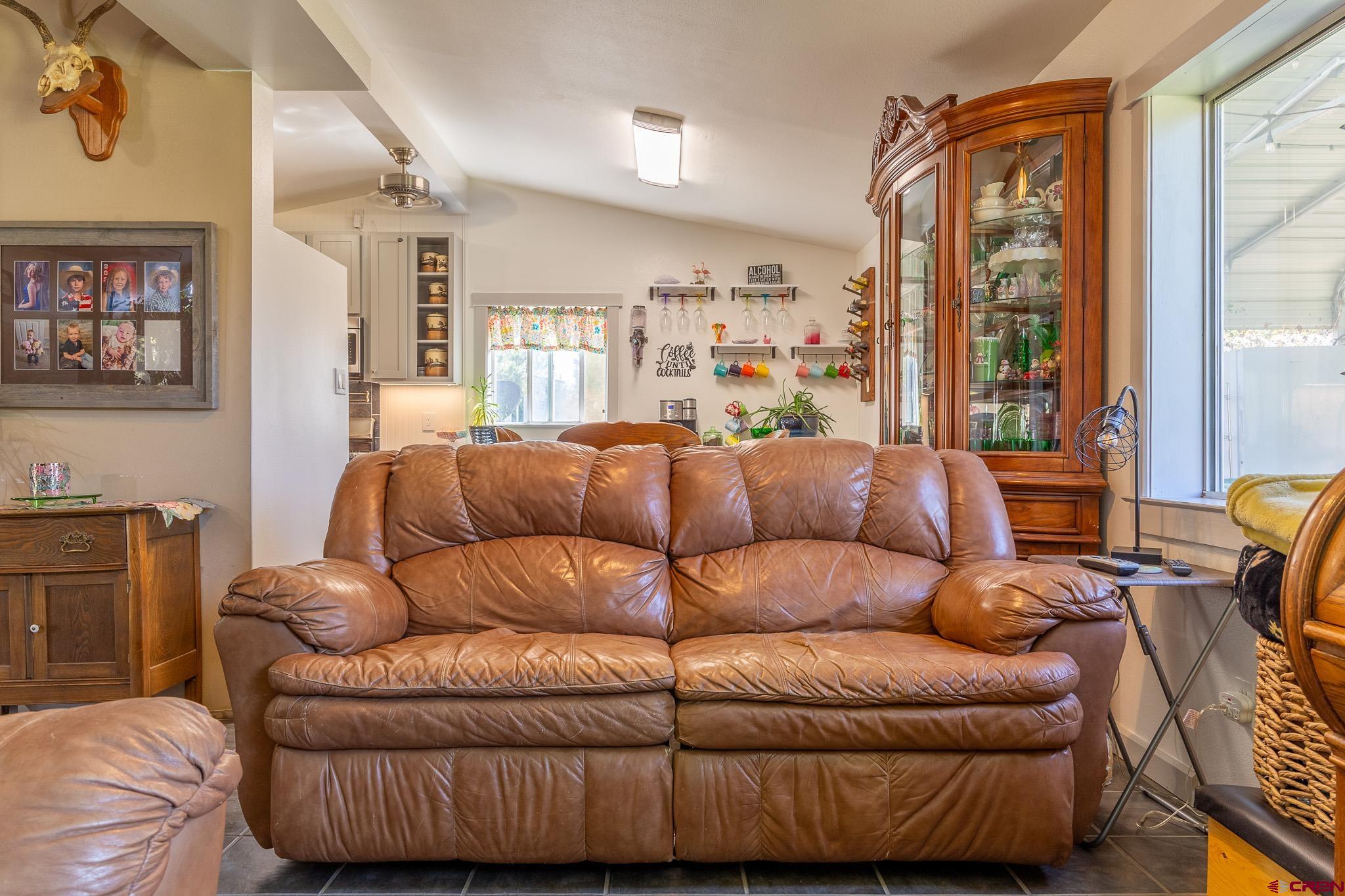 329 Payne Lane Ignacio, CO 81137 - Photo 5 of 45 a living room with furniture a large window and a flat screen tv
