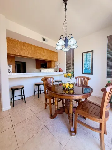a view of a dining room with furniture and a chandelier