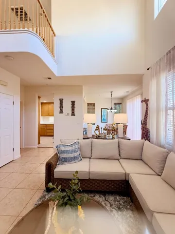 a living room with furniture and a chandelier