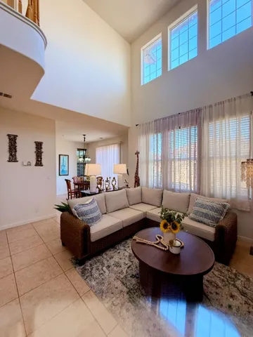 a living room with furniture and a potted plant