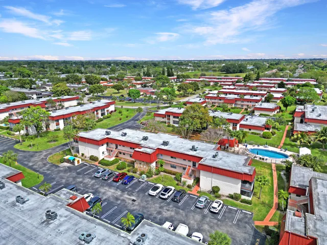 an aerial view of a house with a swimming pool and garden view