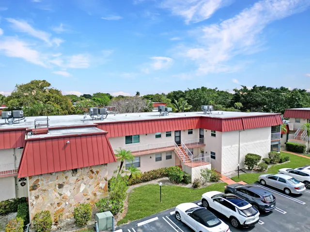 a view of a chairs and table in the backyard
