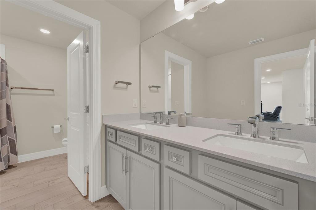 11362 Rising Sun Street Orlando, FL 32829 - Photo 11 of 35 a bathroom with double vanity sinks and a mirror