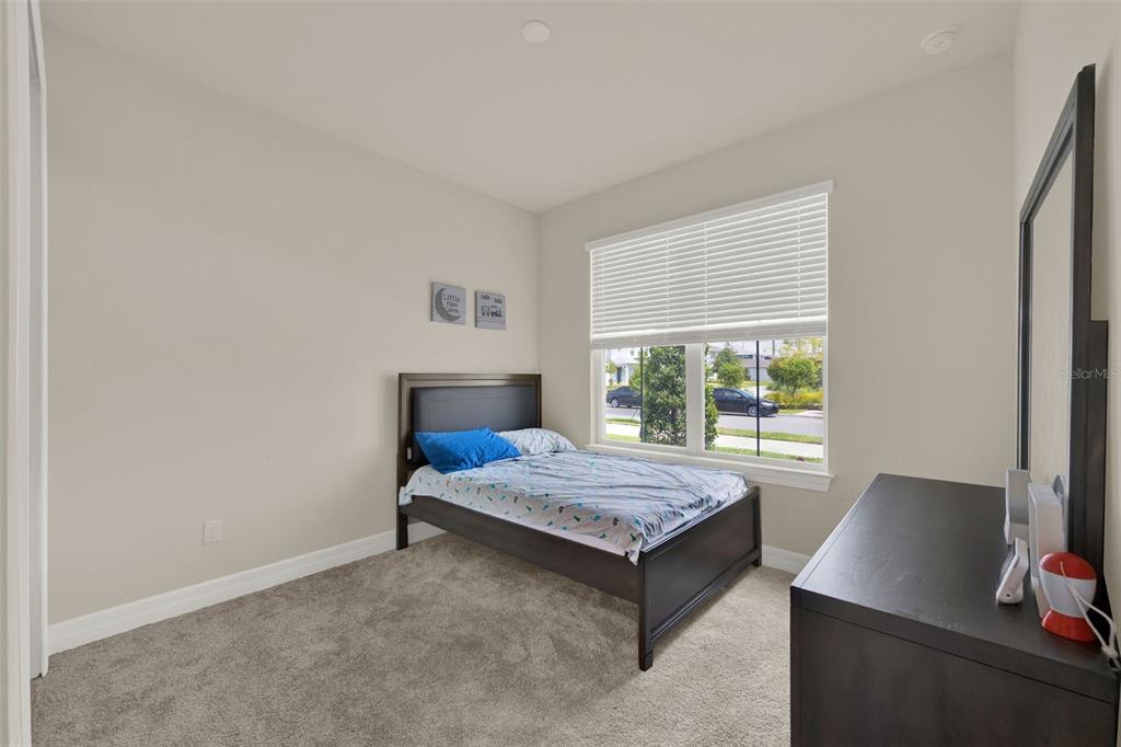 11362 Rising Sun Street Orlando, FL 32829 - Photo 15 of 35 a bedroom with a bed table and a window