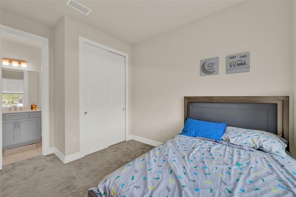 11362 Rising Sun Street Orlando, FL 32829 - Photo 16 of 35 a bedroom with a bed and a painting on the wall