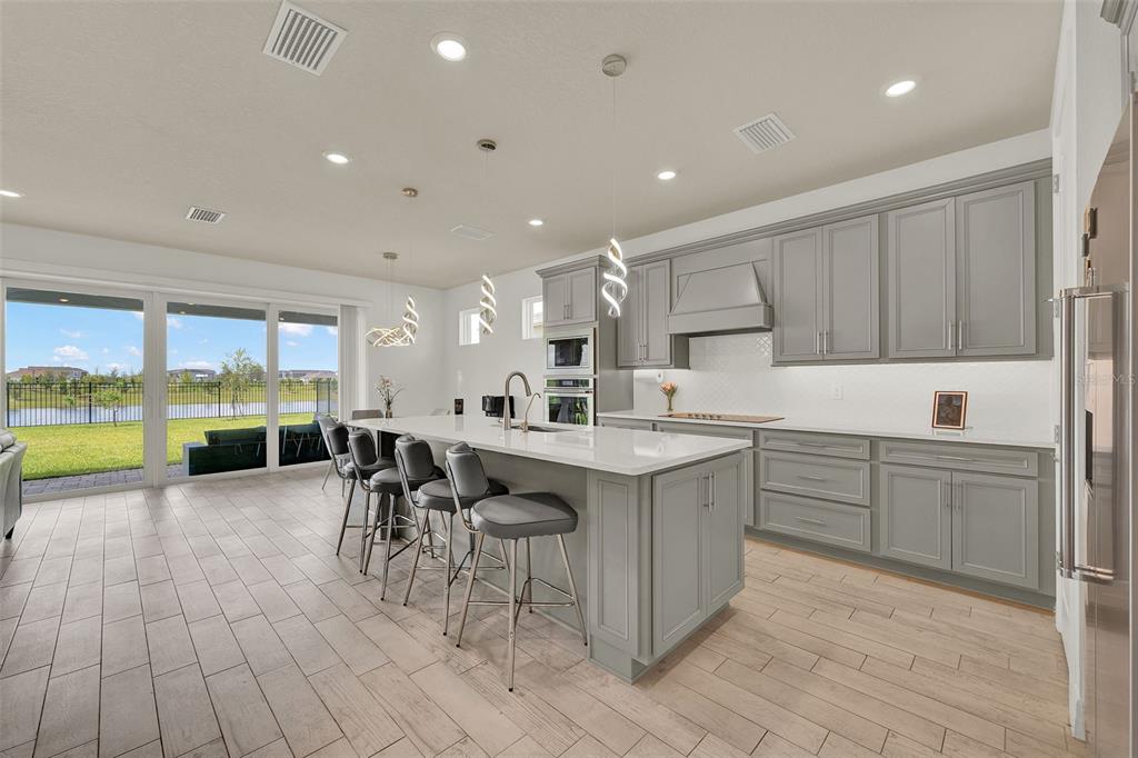 11362 Rising Sun Street Orlando, FL 32829 - Photo 18 of 35 a kitchen with a table chairs sink and cabinets