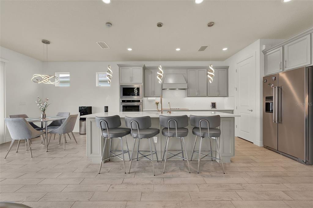 11362 Rising Sun Street Orlando, FL 32829 - Photo 19 of 35 a large kitchen with a table and chairs