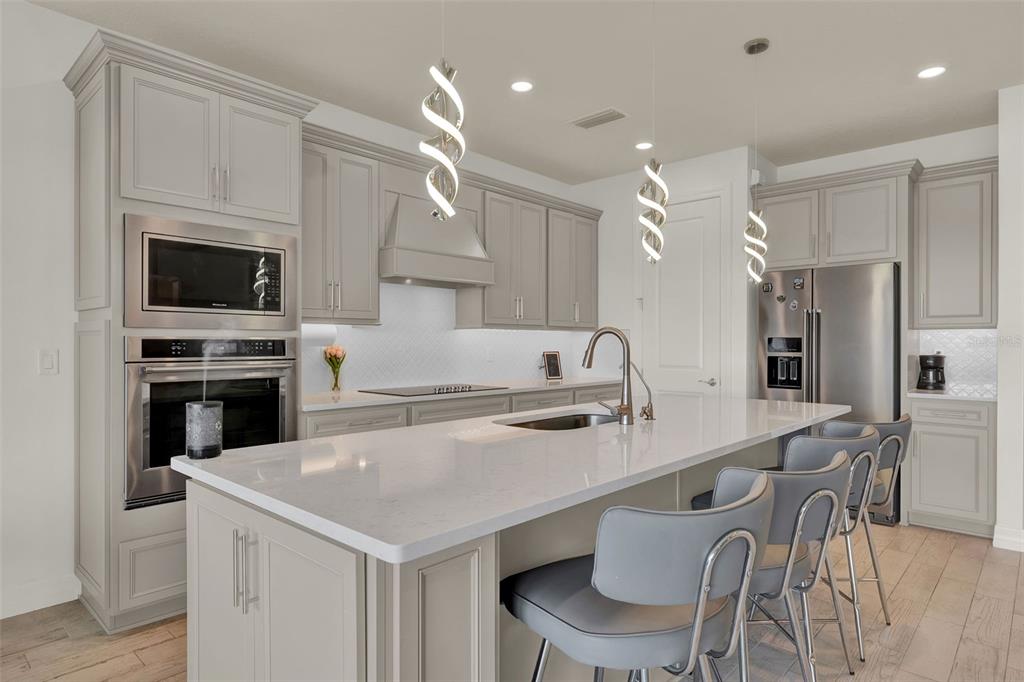 11362 Rising Sun Street Orlando, FL 32829 - Photo 20 of 35 a kitchen with a stove a sink and a refrigerator