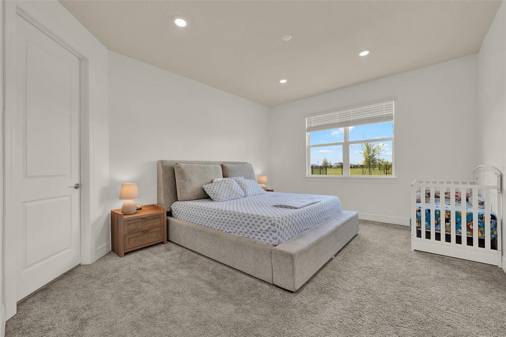 11362 Rising Sun Street Orlando, FL 32829 - Photo 27 of 35 a spacious bedroom with a bed and a window