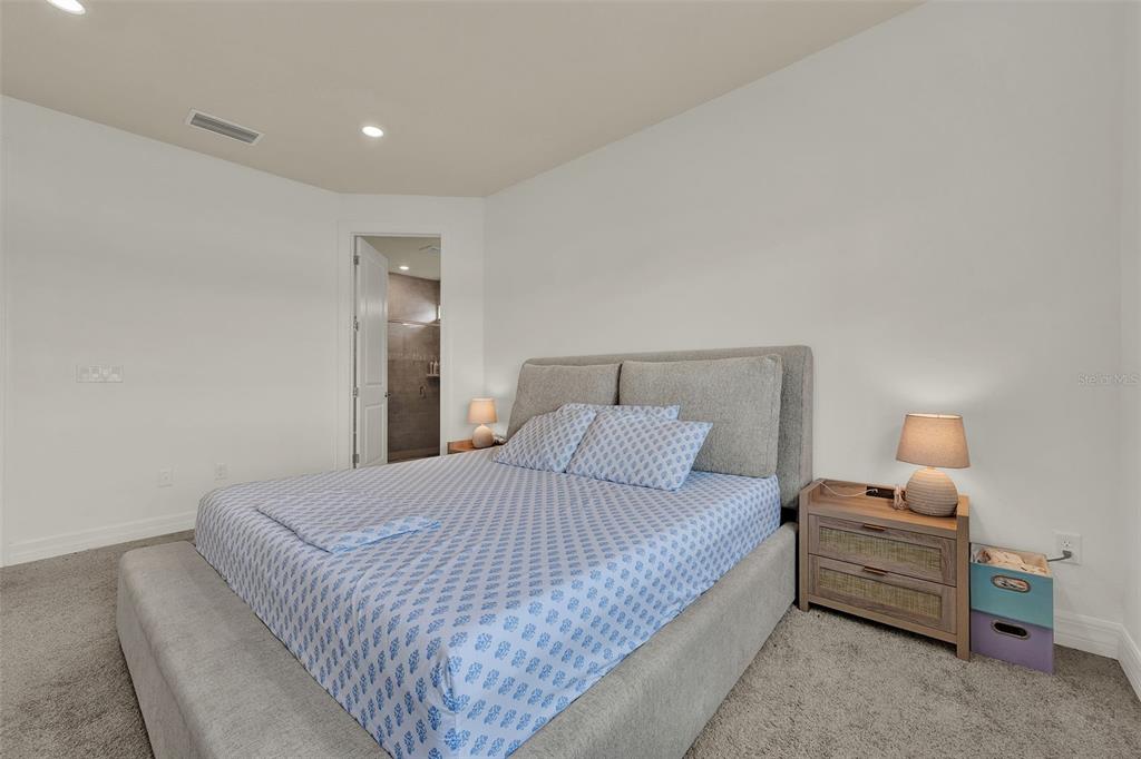 11362 Rising Sun Street Orlando, FL 32829 - Photo 28 of 35 a bedroom with a bed and a night stand