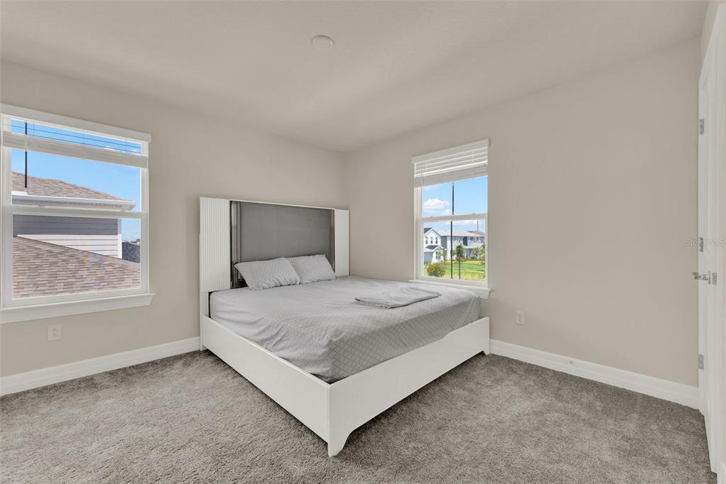 11362 Rising Sun Street Orlando, FL 32829 - Photo 8 of 35 a bedroom with a bed and window