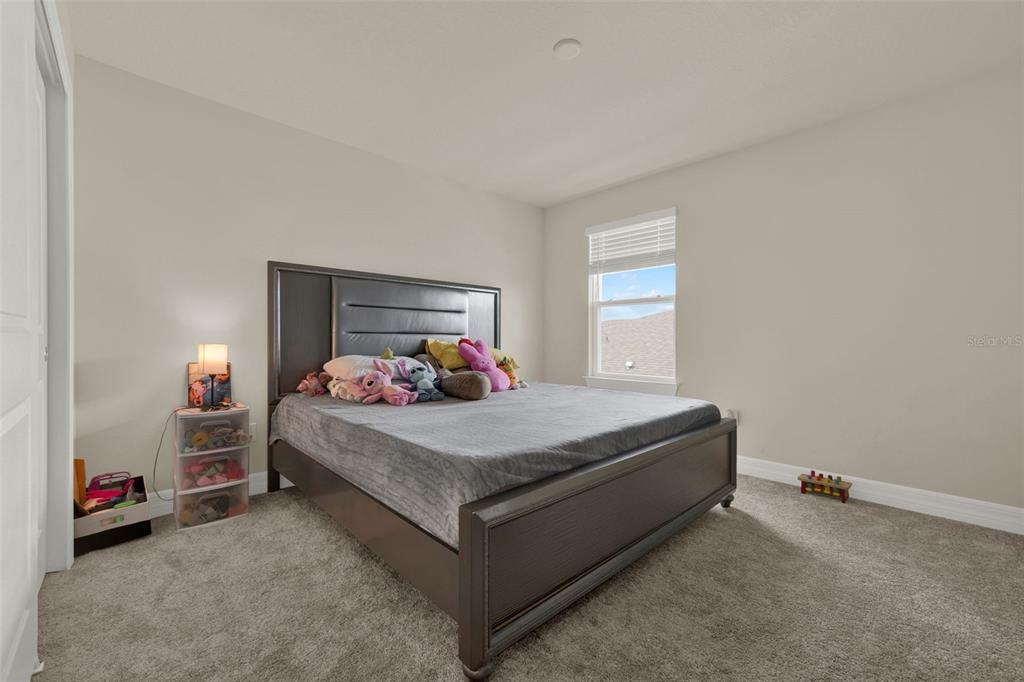 11362 Rising Sun Street Orlando, FL 32829 - Photo 9 of 35 a bed sitting in a bedroom next to a window