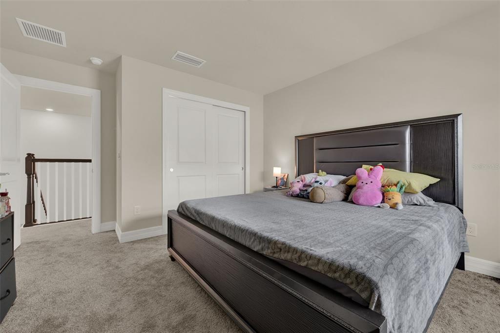 11362 Rising Sun Street Orlando, FL 32829 - Photo 10 of 35 a bedroom with a bed and a potted plant