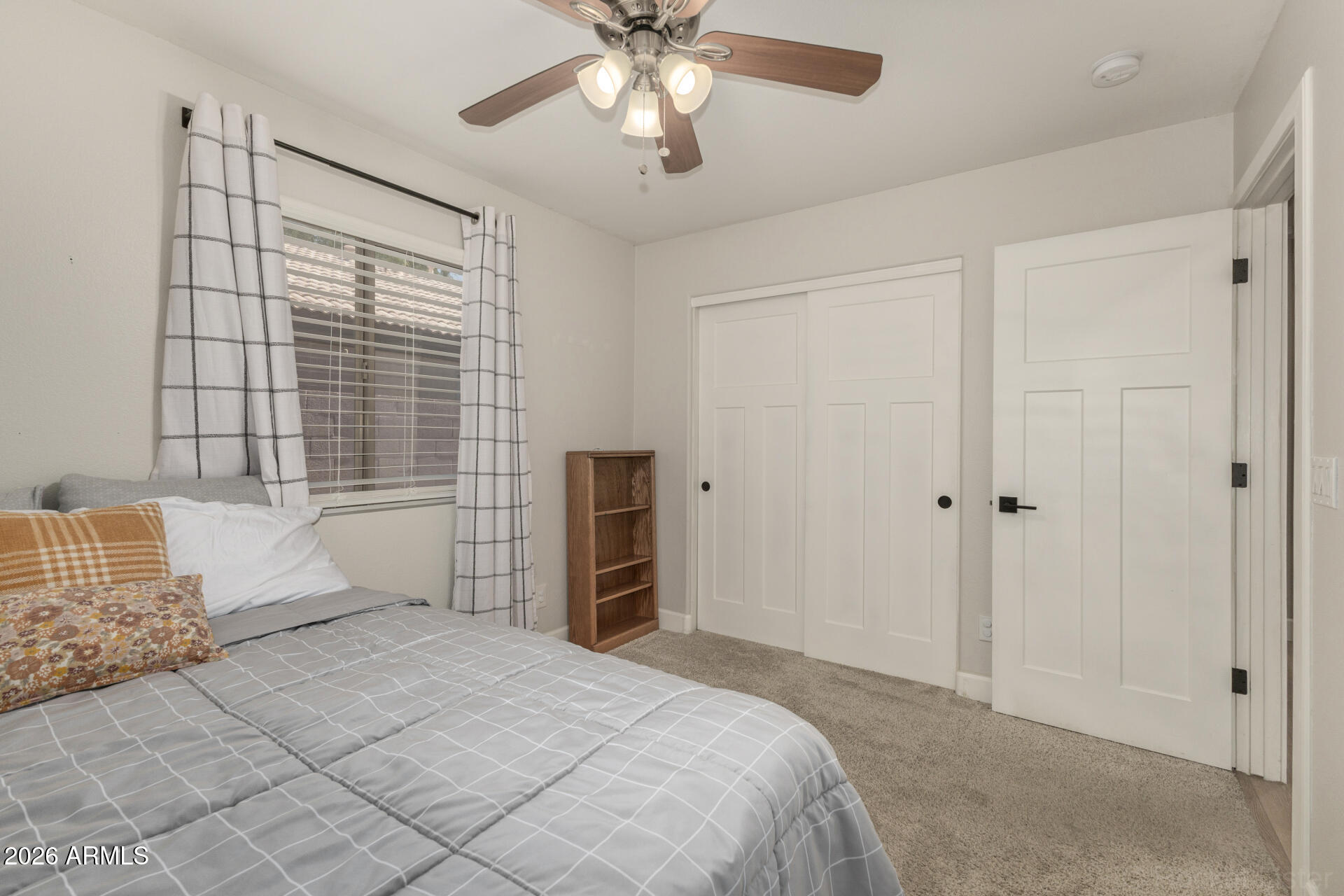 1736 East Robin Lane Gilbert, AZ 85296 - Photo 17 of 25 a spacious bedroom with a bed and a chandelier