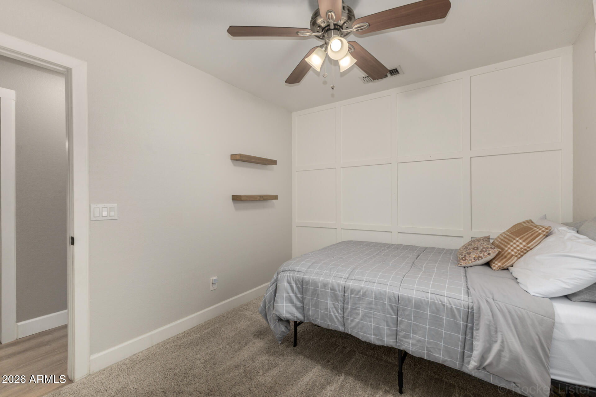 1736 East Robin Lane Gilbert, AZ 85296 - Photo 18 of 25 a bedroom with a bed and a chandelier