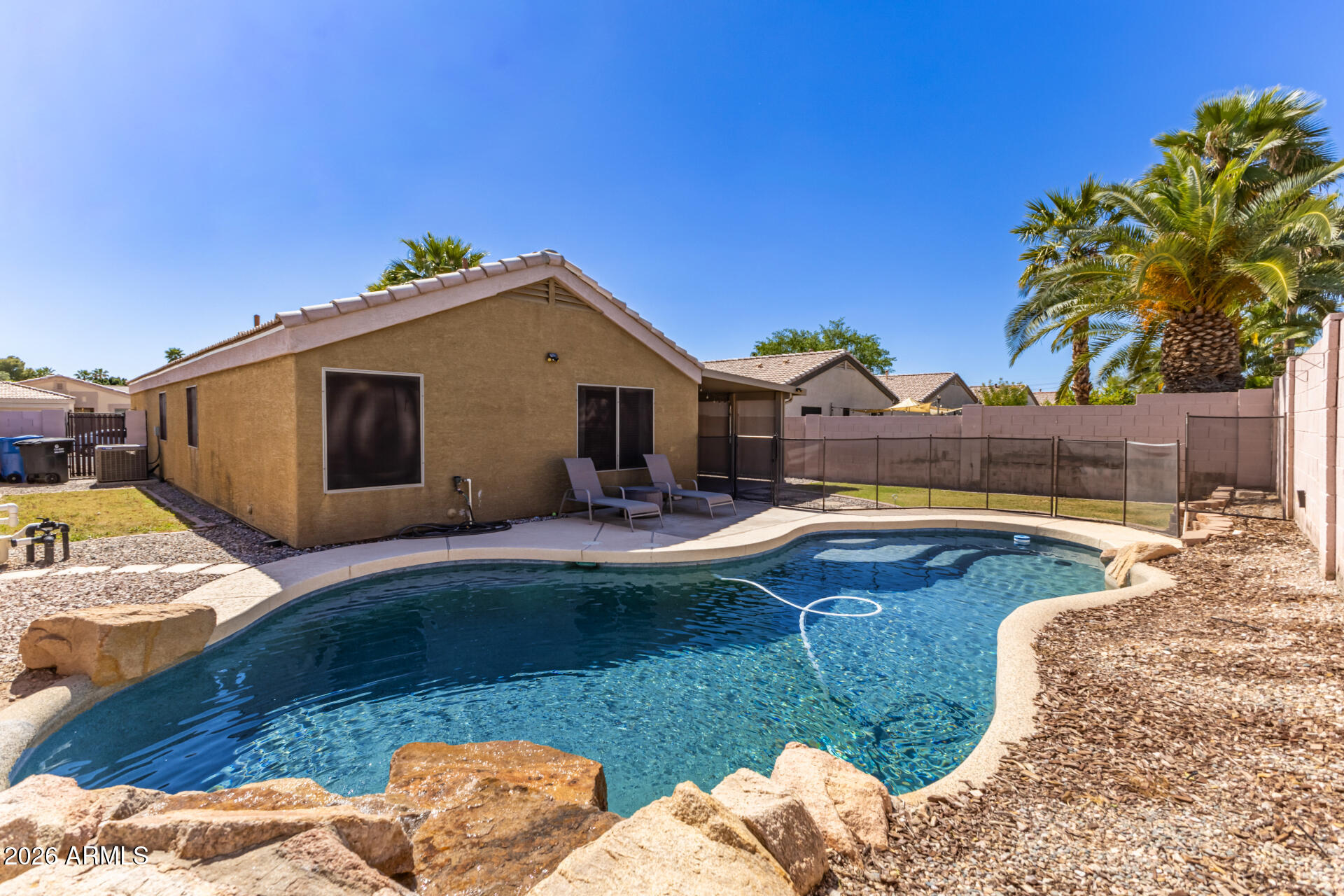 1736 East Robin Lane Gilbert, AZ 85296 - Photo 21 of 25 a front view of a house with swimming pool having outdoor seating