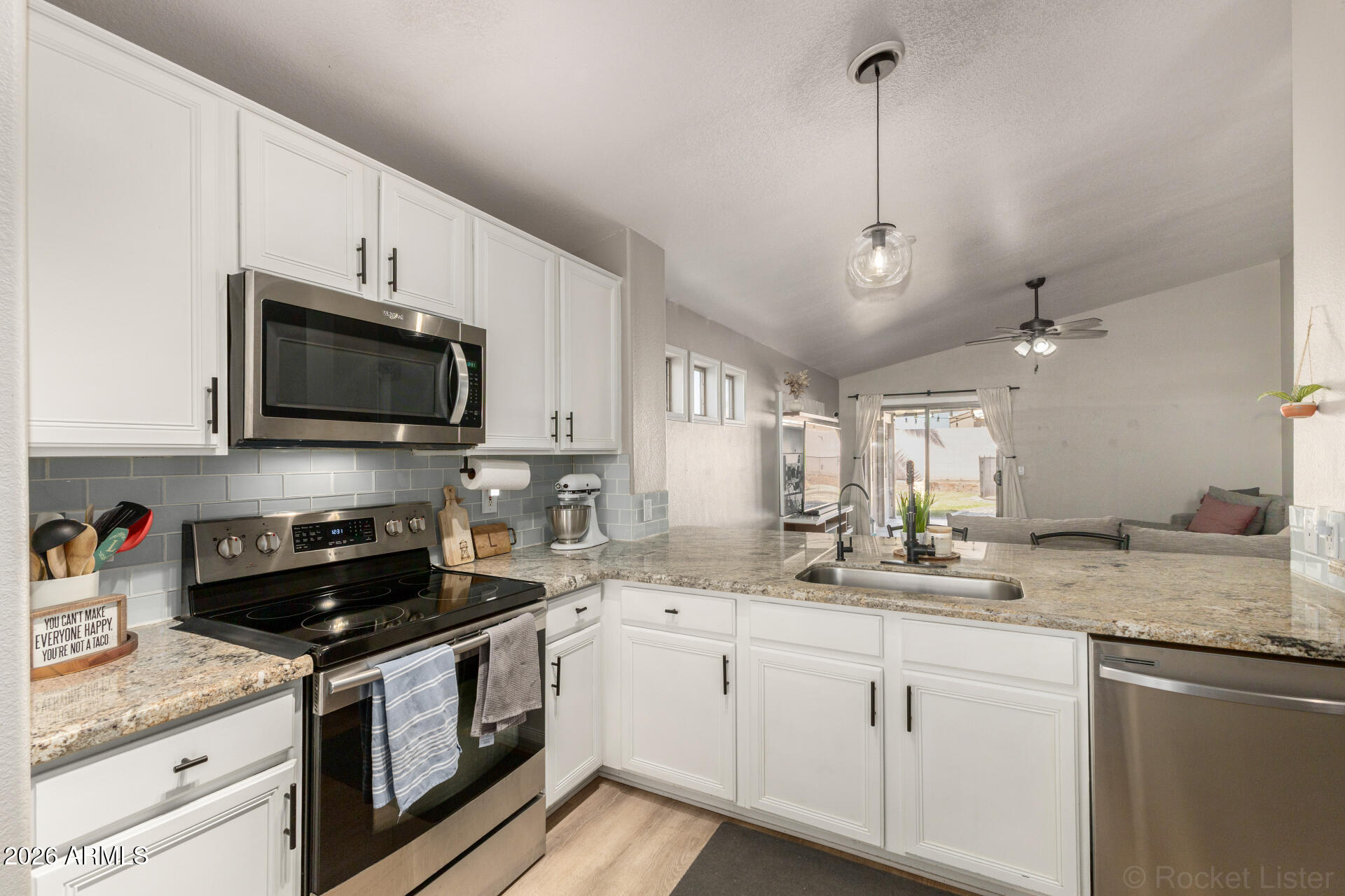 1736 East Robin Lane Gilbert, AZ 85296 - Photo 6 of 25 a kitchen with stainless steel appliances granite countertop a sink a stove and a granite counter tops