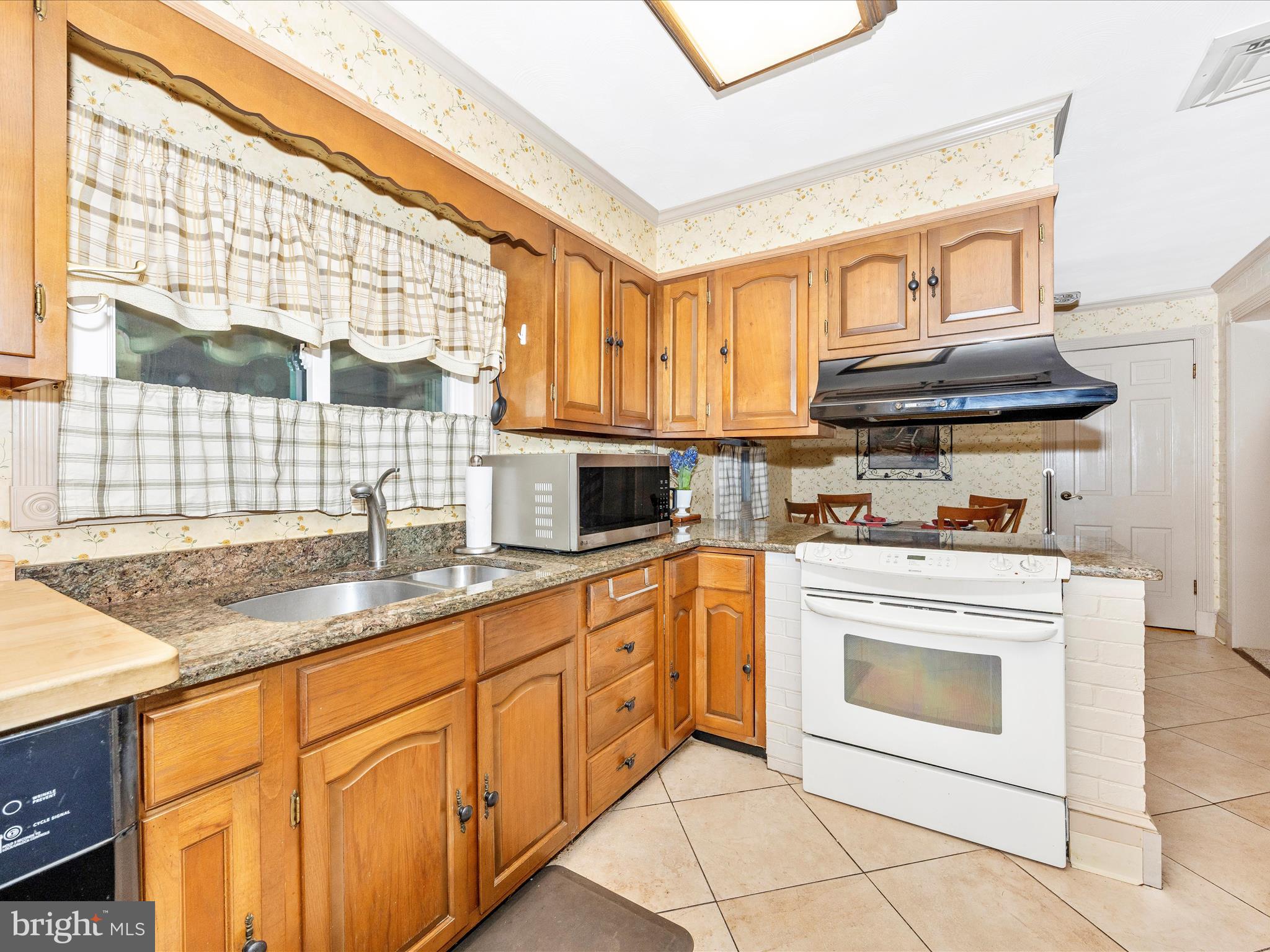 17515 Dr Bird Road Sandy Spring, MD 20860 - Photo 17 of 76 a kitchen with granite countertop a sink stainless steel appliances and cabinets