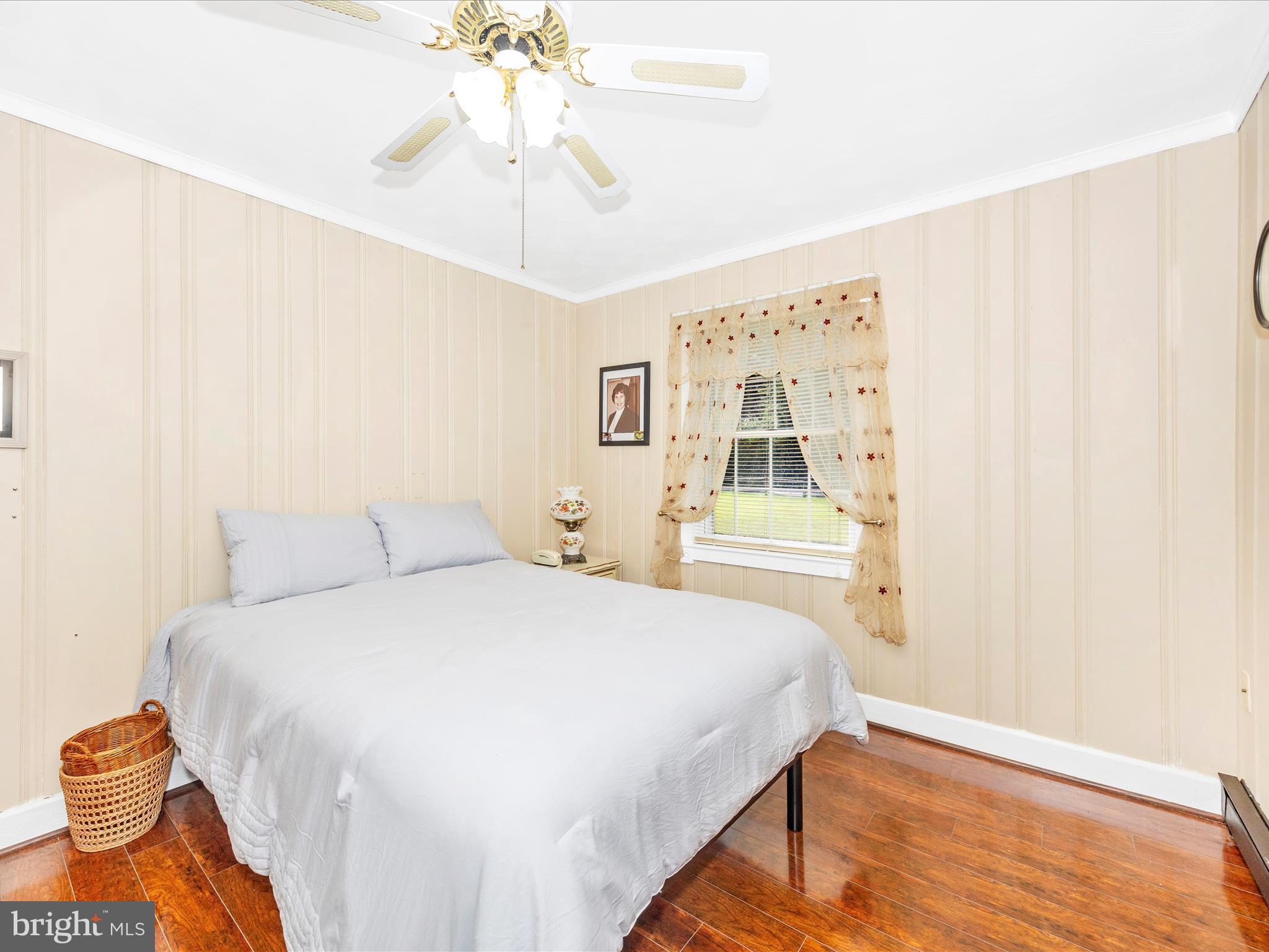 17515 Dr Bird Road Sandy Spring, MD 20860 - Photo 21 of 76 a bedroom with a bed and a chandelier