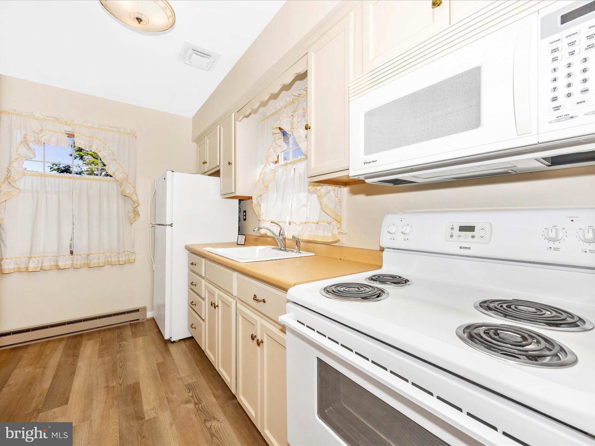 17515 Dr Bird Road Sandy Spring, MD 20860 - Photo 40 of 76 a kitchen with a stove and a white refrigerator