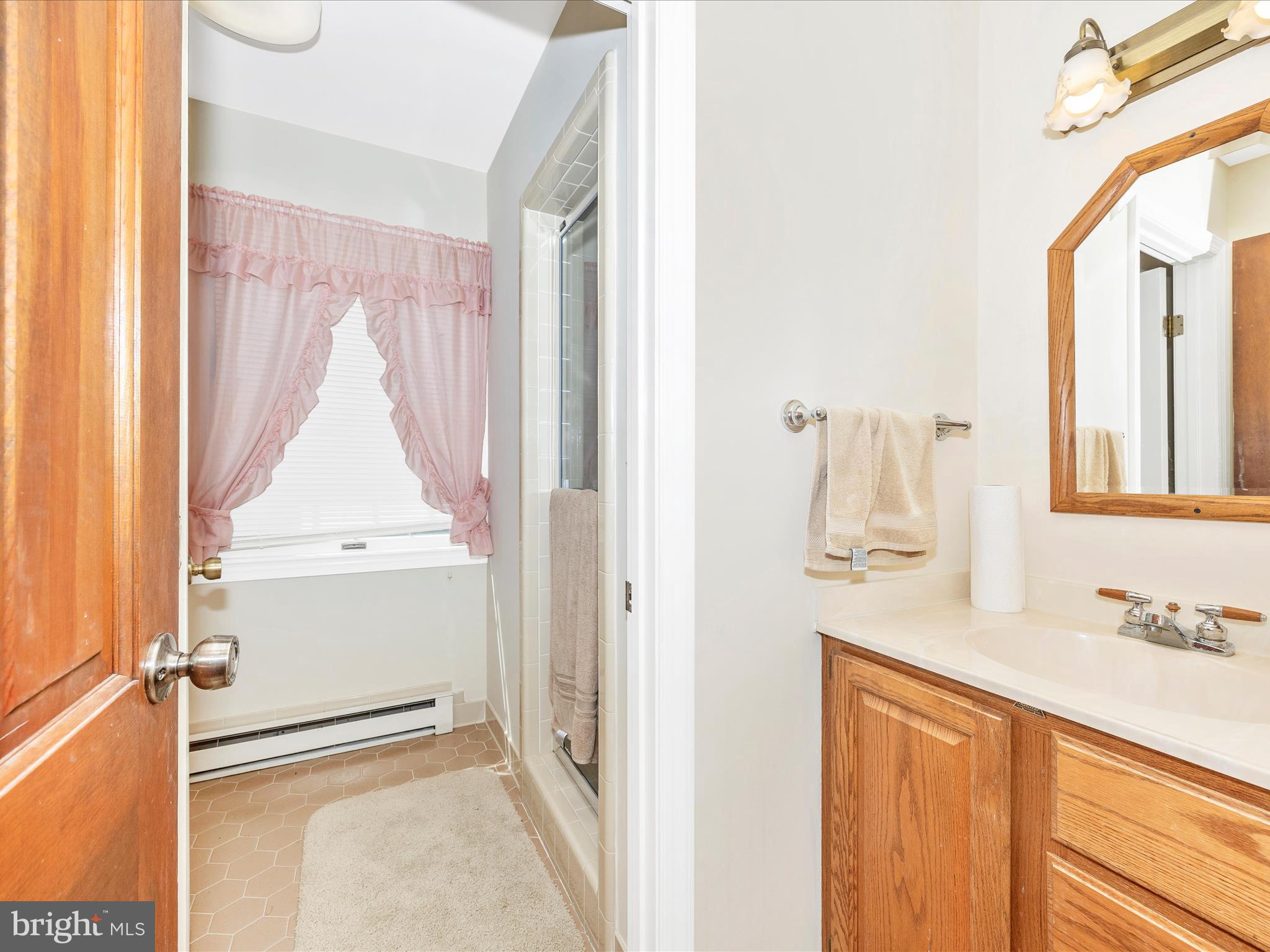 17515 Dr Bird Road Sandy Spring, MD 20860 - Photo 41 of 76 a bathroom with a sink and a mirror