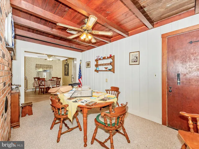a kitchen with granite countertop a sink a stove a washer and dryer next to a window