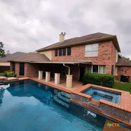 a front view of house with yard slide and outdoor seating