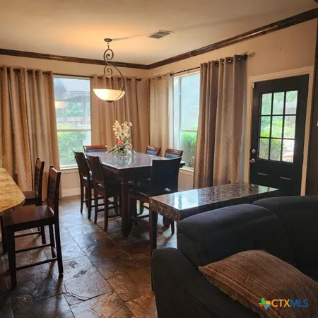 a view of a dining room with furniture and window