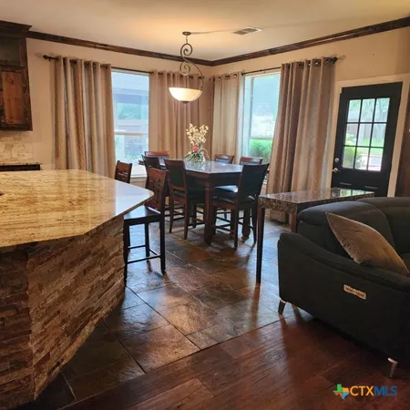 a living room with a fireplace furniture a rug and a large window
