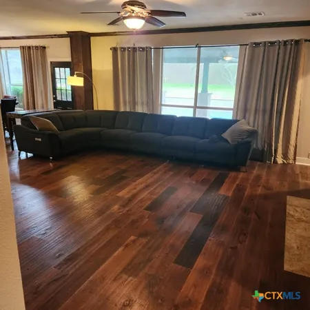 a living room with furniture and wooden floor