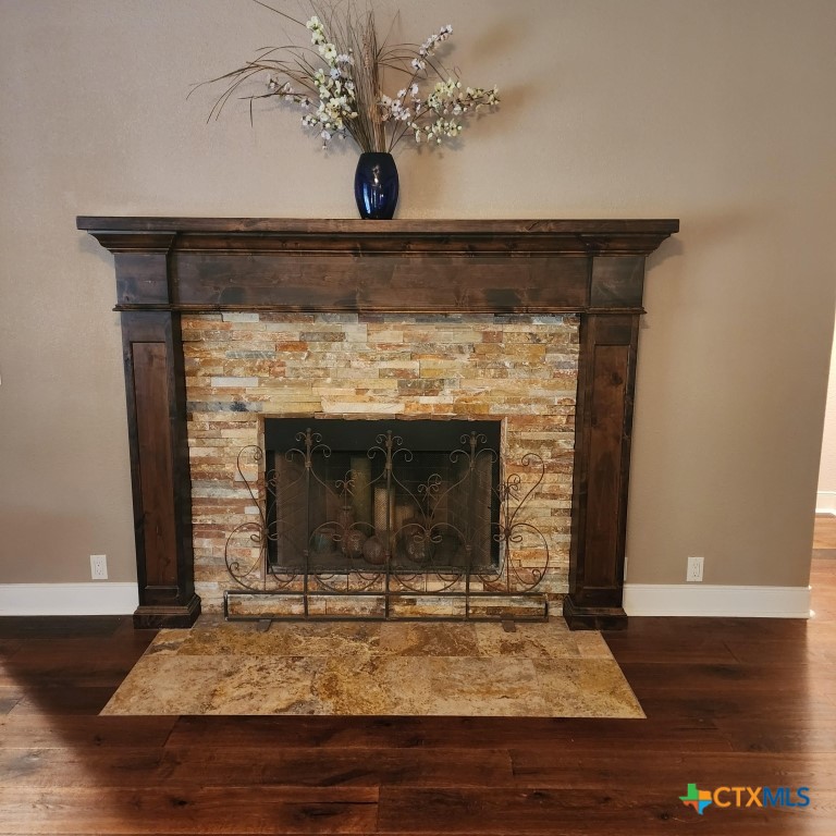 11710 Uplands Ridge Drive Austin, TX 78738 - Photo 16 of 33 a view of fireplace and a wooden floor