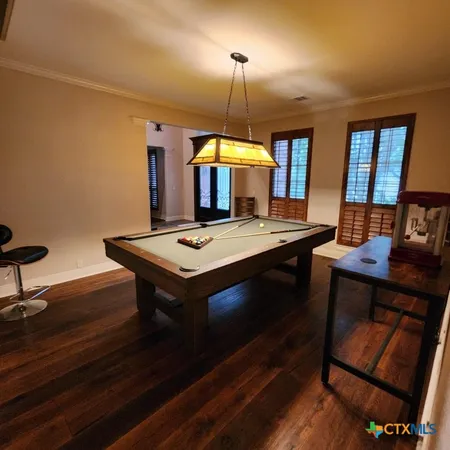 a bedroom with a bed ceiling fan and a window