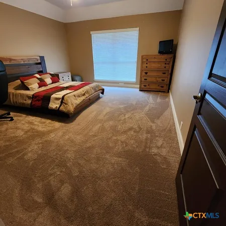 a bedroom with furniture and window