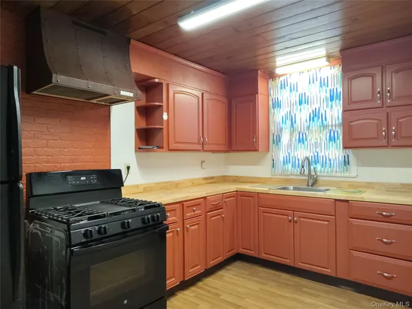 a kitchen with a sink stove and cabinets
