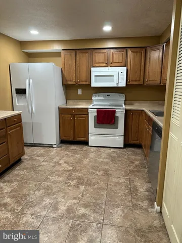 a kitchen with stainless steel appliances a refrigerator and a stove