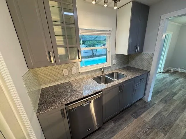 a white toilet sitting next to a bathroom sink and a mirror