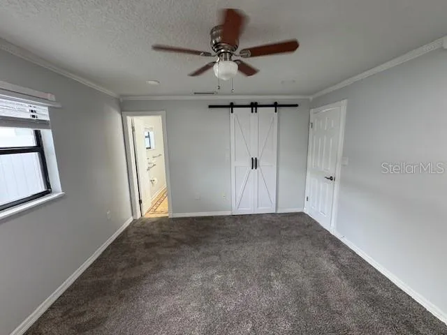 a front view of house with yard and trees around