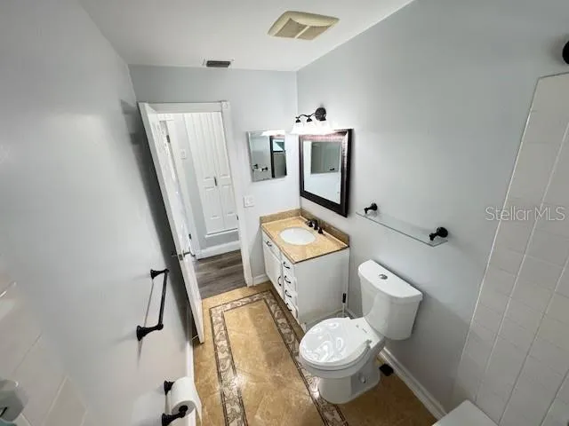 a front view of house with yard and trees in the background