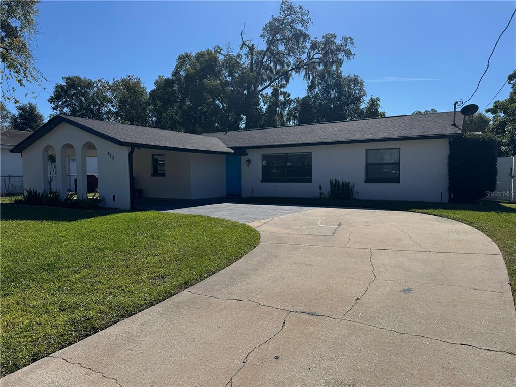 413 Citadel Drive Altamonte Springs, FL 32714 - Photo 37 of 47 a front view of a house with a yard and garage