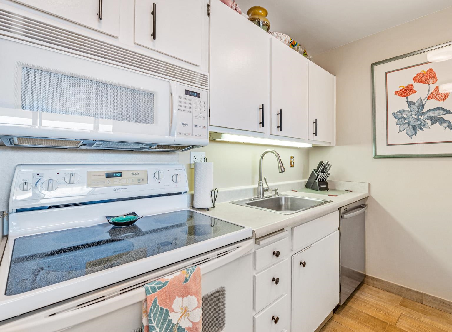 145 North Kihei Road, Unit PH5 Kihei, HI 96753 - Photo 14 of 26 a kitchen with stainless steel appliances granite countertop a sink and white cabinets
