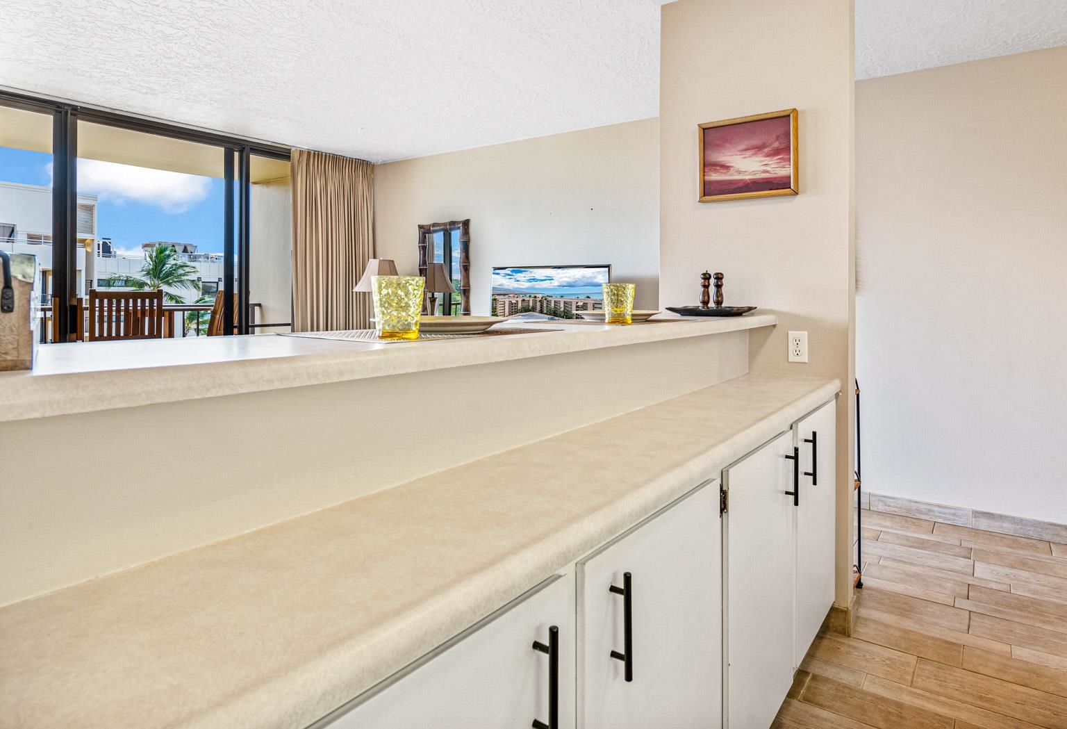145 North Kihei Road, Unit PH5 Kihei, HI 96753 - Photo 18 of 26 a open kitchen with cabinets and a large window
