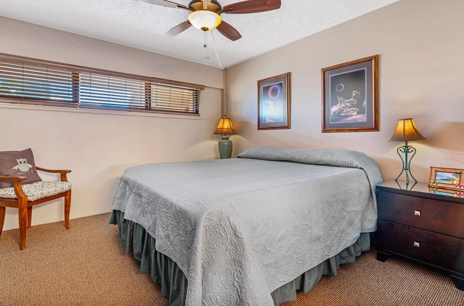 145 North Kihei Road, Unit PH5 Kihei, HI 96753 - Photo 21 of 26 a bedroom with a bed and a chandelier