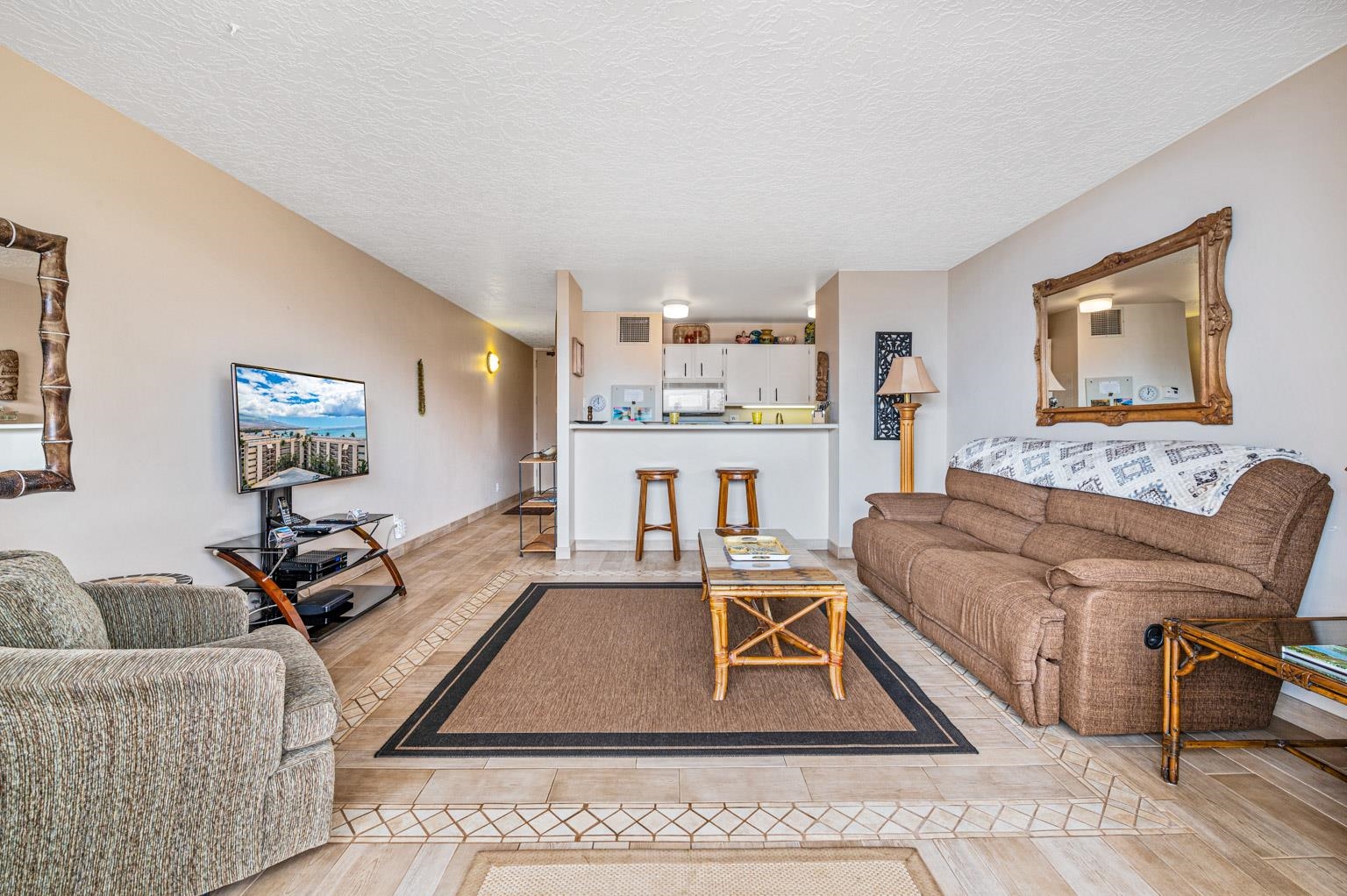 145 North Kihei Road, Unit PH5 Kihei, HI 96753 - Photo 9 of 26 a living room with furniture and a wooden floor