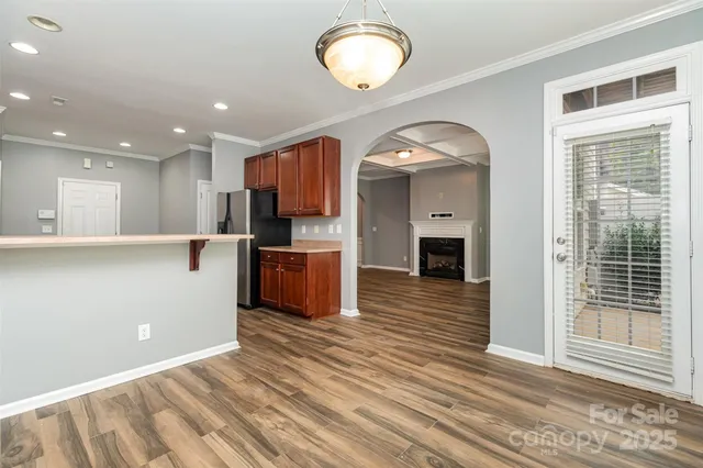 a view of kitchen and hall with wooden floor